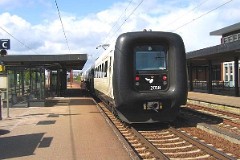 DSB IR4 2018 trainset photographed in Vojens 22. May 2004.  The IR4 was built by ABB Scandia in Denmark. Each unit consists of 3 coaches. Built in a number of 44 trainsets. The trainsets were put in service in 1989 - 1998. 4 electric engines of 420 kW per trainset. Max speed 180 km/h - 112 mph. Length 76 530 mm. Weight 133 metric tonnes. 24/16 seats 1st class, 183/183 + 20 seats 2nd class. Up to 5 trainsets can be put together.